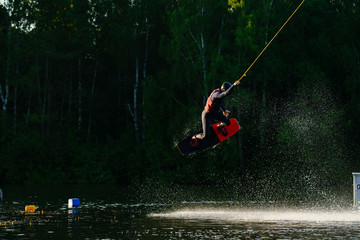 man wakeboarding and jumping