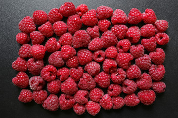 fresh raspberries on black background