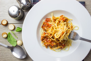 Spaghetti bolognese pasta with tomato sauce,homemade healthy italian pasta on wooden background