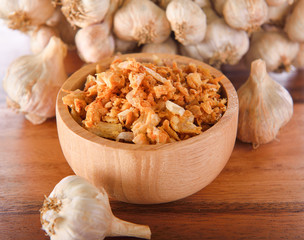 fried garlic on wooden bowl