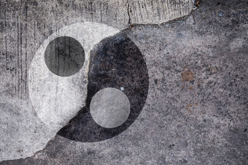 Ying Yang symbol on cracked concrete