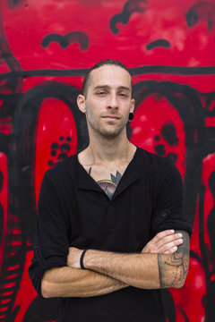Portrait of man in front of a graffiti wall