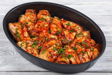 raw juicy chicken wings marinated for roast