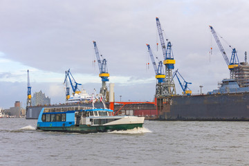 Boat with tourists goes on Elbe river in Hamburg, Germany