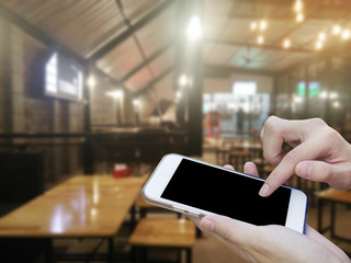 Woman using touch screen mobile phone with blur bar background