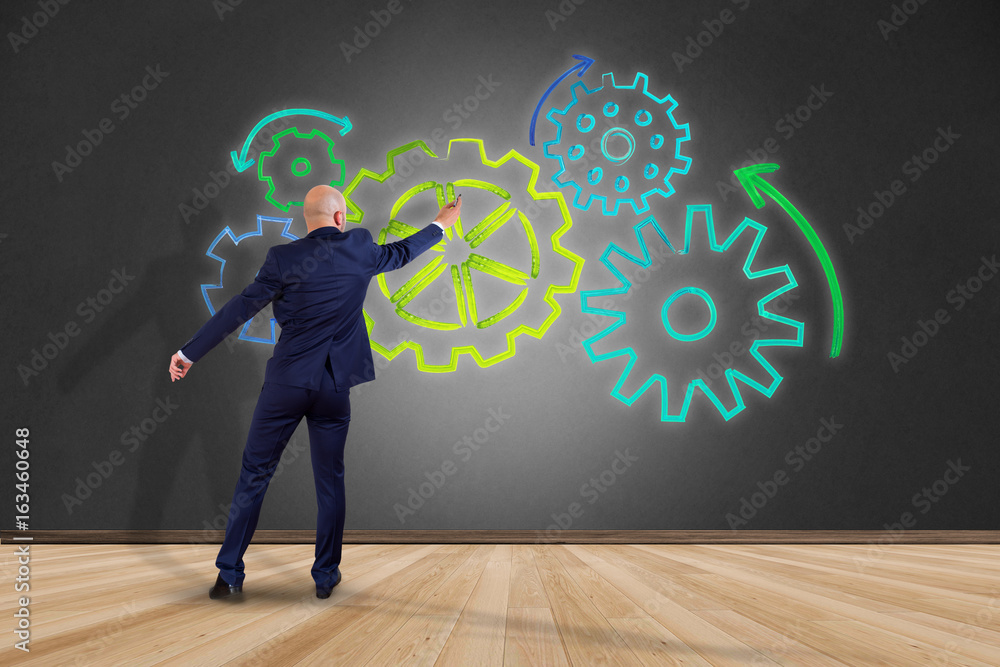 Aufkleber businessman in front of a wall with a cogwheel interface setting with different colors - technology 
