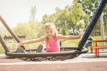 Blonde little girl on the swing.