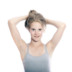  young teen girl holds blond hair up against white background