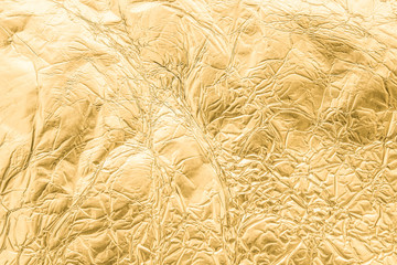 Gold wrinkled paper texture abstract background