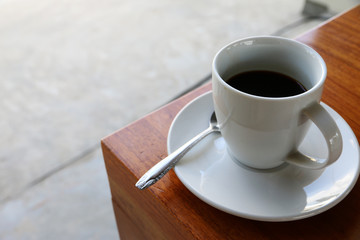 cup of hot coffee Americano on the wood table in coffee shop cafe