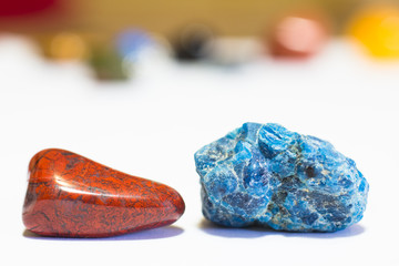 Precious stones - polished red jasper & blue Apatite crystal (on white)