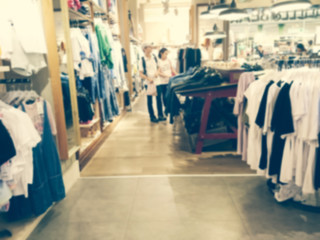 Blurred interior fashion clothes store.