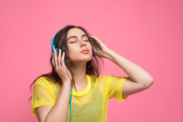 Girl listening music in blue headphones