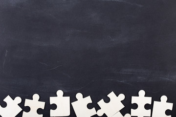 Business solution concept jigsaw on the blackboard