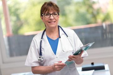 Portrait of female doctor holding a clipboard