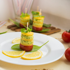Appetizer. Canapes of cheese, cream cheese with garlic, parsley, basil, sorrel and cherry tomatoes