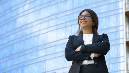 Portrait of young beautiful business woman (student) in suit, glasses, smiling, successful looking...