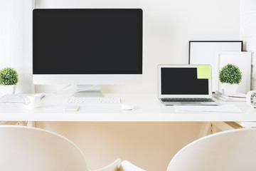 Designer desktop with computer and notebook front