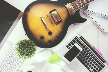 Desktop with smartphone and guitar