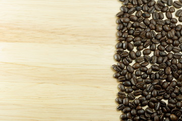Coffee beans on wood background with copy-space