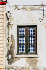A window in a wooden house in Costa Nova. Aveiro. Portugal.