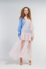 Beautiful girl in studio in fashion clothes on a white background