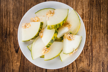 Wooden table with Futuro Melons (selective focus)