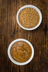 Wooden table with Sweet Mustard (selective focus)