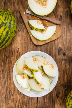 Portion of Fresh Futuro Melon on wooden background (selective focus)