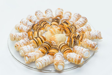 traditional austrian cream pastry on a plate - schaumrolle, kremrole, shillerlocke