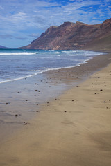Beautiful sandy beach Caleta de Famara on Lanzarote island, Canary Islands, Spain