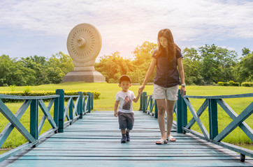 mom and child stay in the park on holiday
