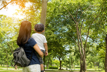 mom and child stay in the park on holiday