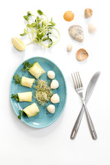 Naklejka na ściany i meble Spring rolls with zucchini and mozzarella cheese. Food with micro greens on white background.