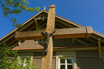 A wooden cross with a statue of Jesus 