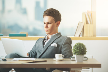 Focused businessman using laptop