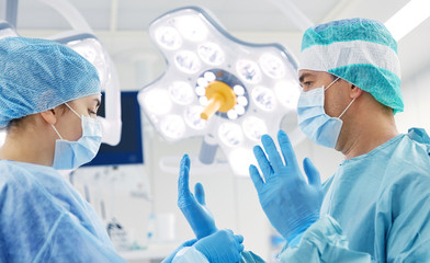 surgeons in operating room at hospital