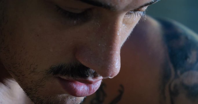 A professional boxer, thinks about fighting, in a good body, elastic bandages, punches bag. Concept: love sports, training, endurance, willpower, technique, strategy, defense, stance, muscles reaction