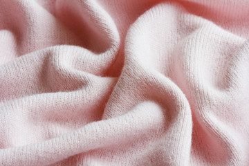 surface of a soft knitted fabric made of cashmere with large folds, a detail of clothes