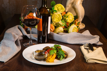 Grilled vegetables. Vegetables grilled with wine on the table in the restaurant interior