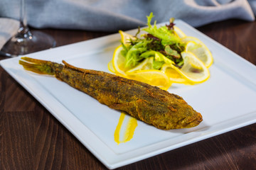 Fried fish. Fish steers. Fish fried in flour with garnish