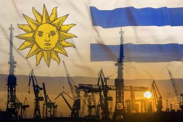 Industrial concept with Uruguay flag at sunset