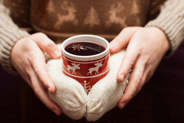 swedish glogg or mulled wine in knitted gloves.