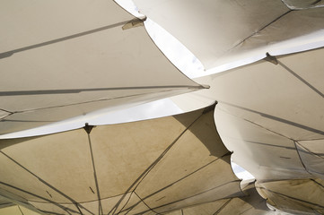 Detail of architecture - white stretched umbrellas as roof