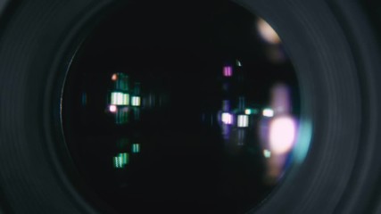 Photographic camera lens. The camera while shooting macro. The camera is in the process of close-up shooting. Shutter release in slow motion.