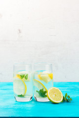 Lemonade homemade drink - two glasses with lemonade, ice and mint