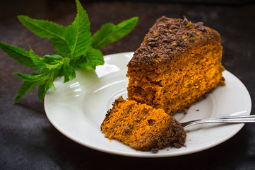 Cake with chocolate, honey and mint. Black background. Top view. Close-up