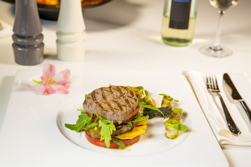 Grilled meat with vegetables served as a sandwich.