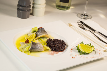 Baked fillet of Dorado fish with garnish of red rice