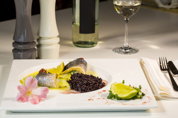 Baked fillet of Dorado fish with garnish of red rice